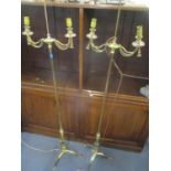 A pair of brass two branch standard lamps having rope twist decoration and on tripod bases 60 3/4"h