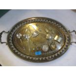 A silver plated twin handled tray containing a quantity of small silver items to include dolls house
