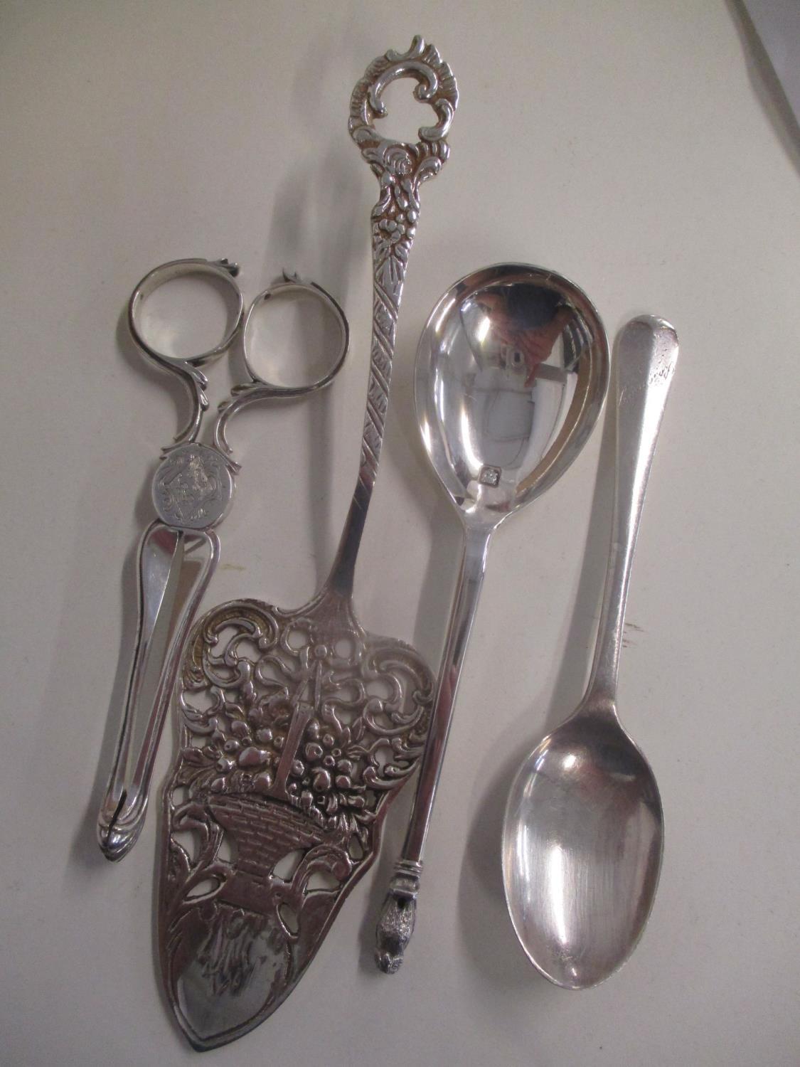 Three pieces of silver to include a pair of scissor sugar tongs, together with a white metal