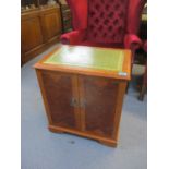 A reproduction yew cabinet with a green leather scriber