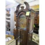 A reproduction long case clock with broken swan neck pediment, turned finial, brass arched dial,