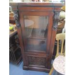 A Victorian mahogany display cabinet/bookcase having a glazed door above a cupboard door with