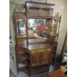 A late Victorian rosewood cabinet having a raised mirrored back, turned supports, Sheraton revival