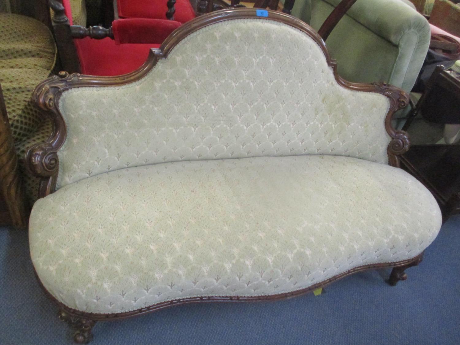 A Victorian walnut framed salon sofa having scroll supports and short cabriole feet, 32 1/2"h x 53