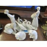 Two Lladro models of polar bears, a Lladro group of three geese and three Lladro figures