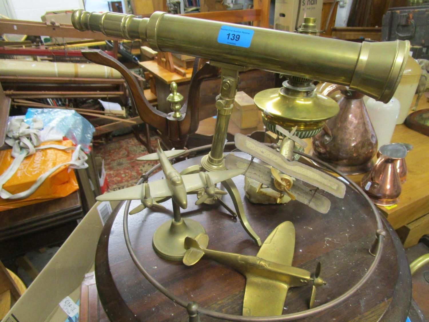 A reproduction brass telescope on tripod base, a metal model of a bi-plane mounted on an onyx - Image 2 of 4