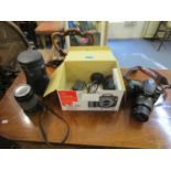 A Canon 35mm SLR with telescopic lens and a Canon 300 camera and miscellaneous lenses and cards,