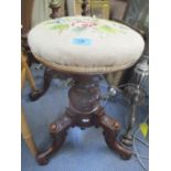 A Victorian mahogany piano stool having a tapestry swivel top and scroll shaped feet 19 1/2"H x 15