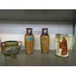 Royal Doulton stoneware to include a pair of vases, a three handled vase and a series ware jug