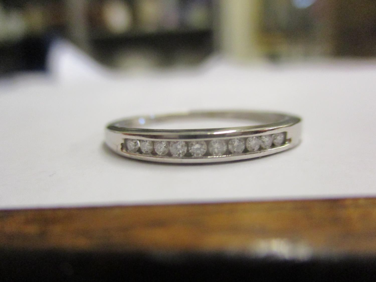 A 9ct white gold eternity style ring set with ten diamonds