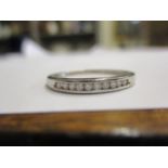 A 9ct white gold eternity style ring set with ten diamonds