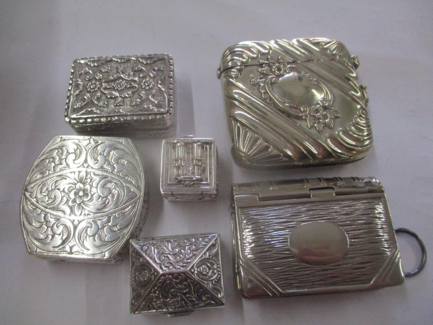 A mixed lot of white metal and silver plated items to include a vesta case, a stamp and vesta case