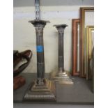 A pair of silver plated candlesticks on stepped base 11" high