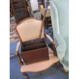 A salon armchair with a peach coloured upholstery, together with a mahogany magazine rack and a