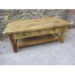 A mango wood coffee table with three small drawers and shelf below