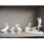 A Lladro model of a boy and girl on a seesaw together with three Lladro models of geese