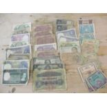 A quantity of mid 20th century worldwide banknotes to include Military Authority notes of Tripoli