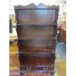 A late 20th century mahogany waterfall bookcase above two short drawers 58" x 30" x 15"