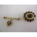 Two gold coloured brooches