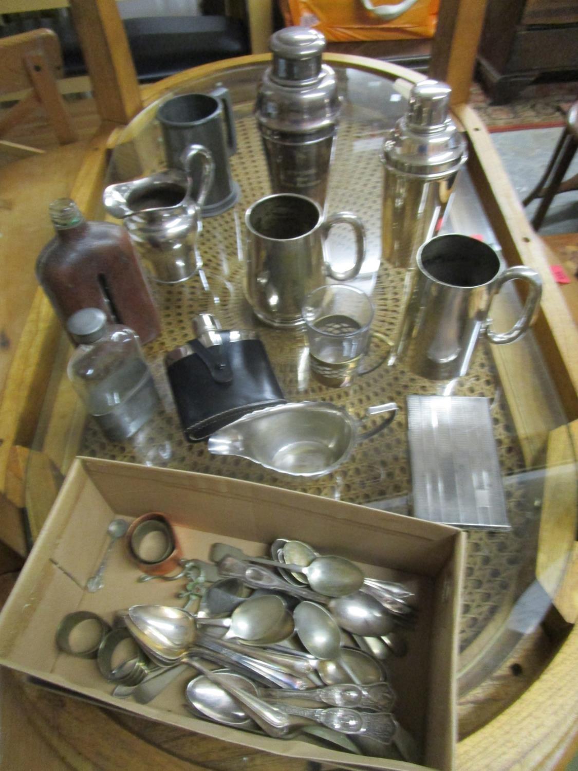 A mixed lot of Old Sheffield plate and silver plate to include hip flasks, cocktail shakers, one