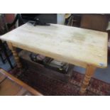 A pine dining table having a single inset drawer and turned legs and a set of six slat back dining