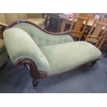 A Victorian mahogany chaise longue having scroll support