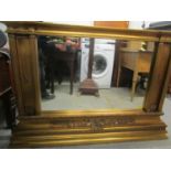 A contemporary gilt framed over-mantle mirror, a stepped top over a shell motif and scrolled leaf