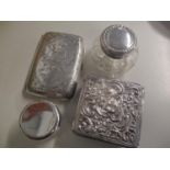 An early 20th century silver cigarette case, together with two silver topped pots and a silver and