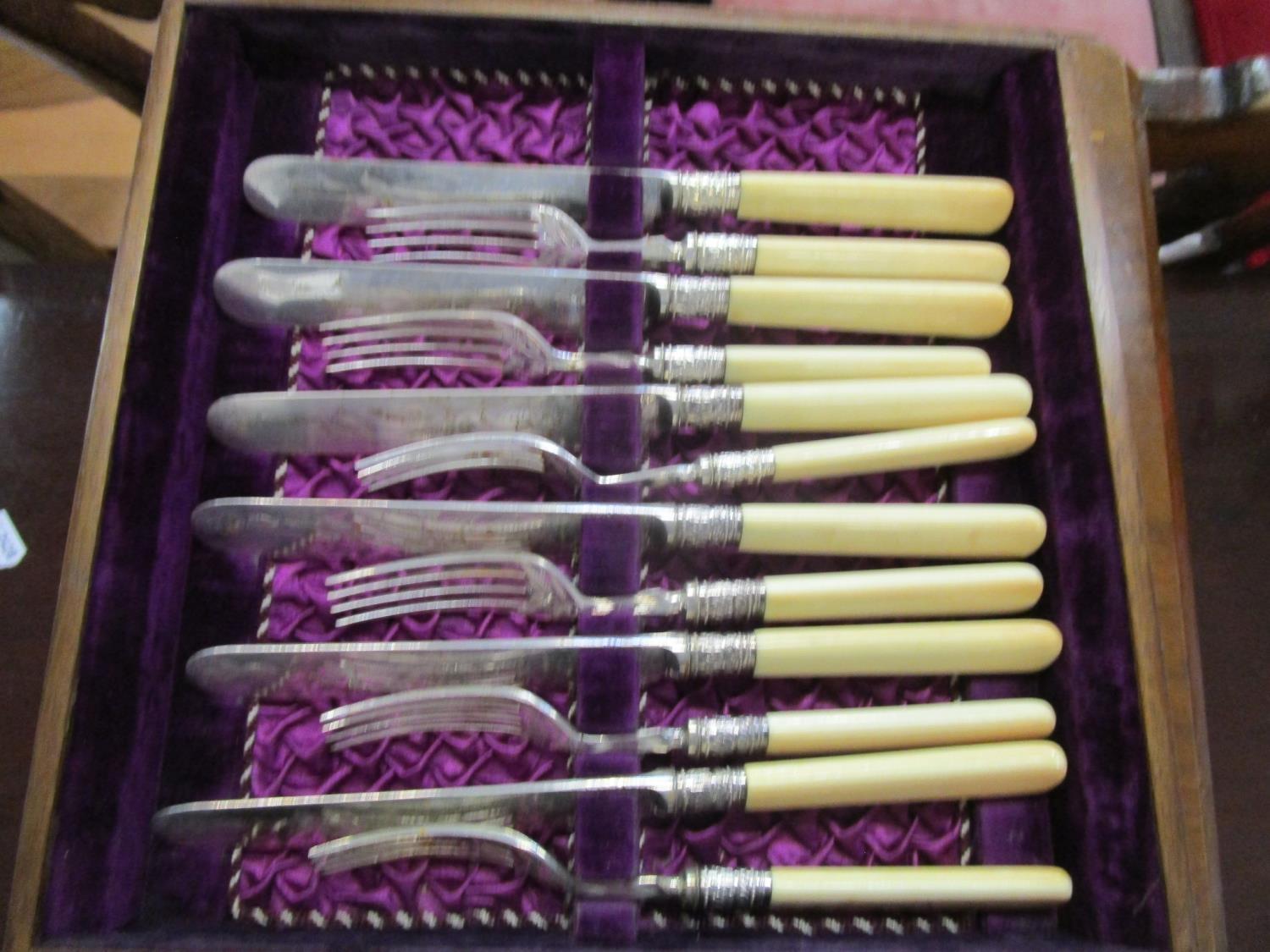 A Victorian walnut cased canteen of silver plated cutlery, three drawers containing a front set with - Image 3 of 7