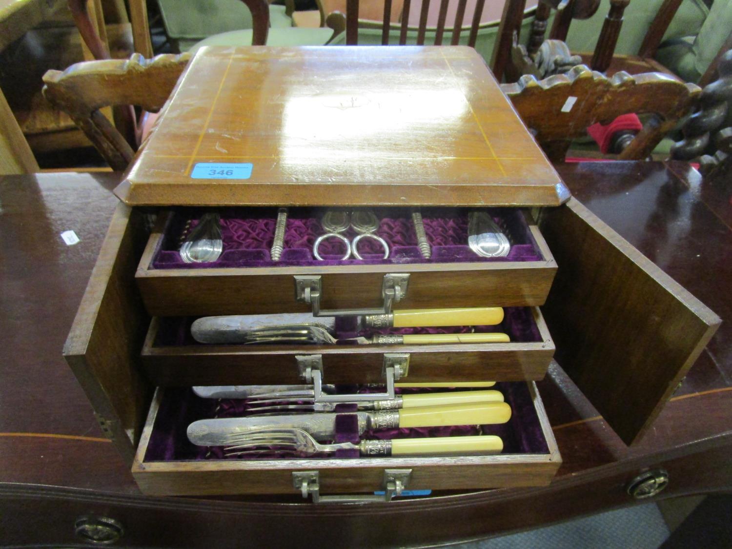 A Victorian walnut cased canteen of silver plated cutlery, three drawers containing a front set with