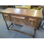 An early 20th century oak sideboard having three drawers with brass drop handles, 36 1/2"h x 51 1/