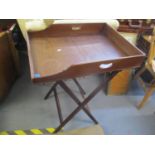 A 19th century mahogany butlers tray table 34 1/2"h x 25 1/4"w