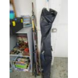 A mixed lot of fishing equipment, books and DVDs to include several rods and a bait box