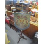 A Victorian walnut and brass pole screen having a floral hanging tapestry, fluted column and three