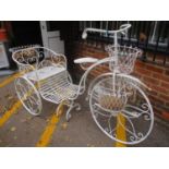 A white painted ornamental garden planter in the form of a bicycle having four hanging baskets 49