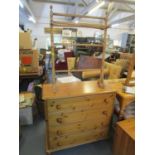 A modern pine chest of four drawers on turned feet and a Victorian pine towel rail