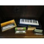 A Hohner Achro Monica boxed musical instrument, a Zigeunerkarten Hohner harmonica, a Ridley's