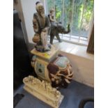 A Japanese export plant stand in the form of a ceramic elephant, together with a figure of a