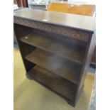 A reproduction oak bookcase having three shelves