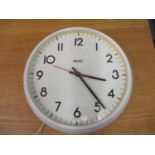 A vintage Smith electric clock in a white plastic case