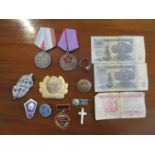 A group of Russian medals, badges, bank notes to include a Gold Star of Lenin Labour of Valour medal