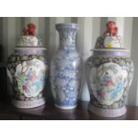 A pair of Chinese large vases having dogs of foo finials to the lids and a large blue and white vase