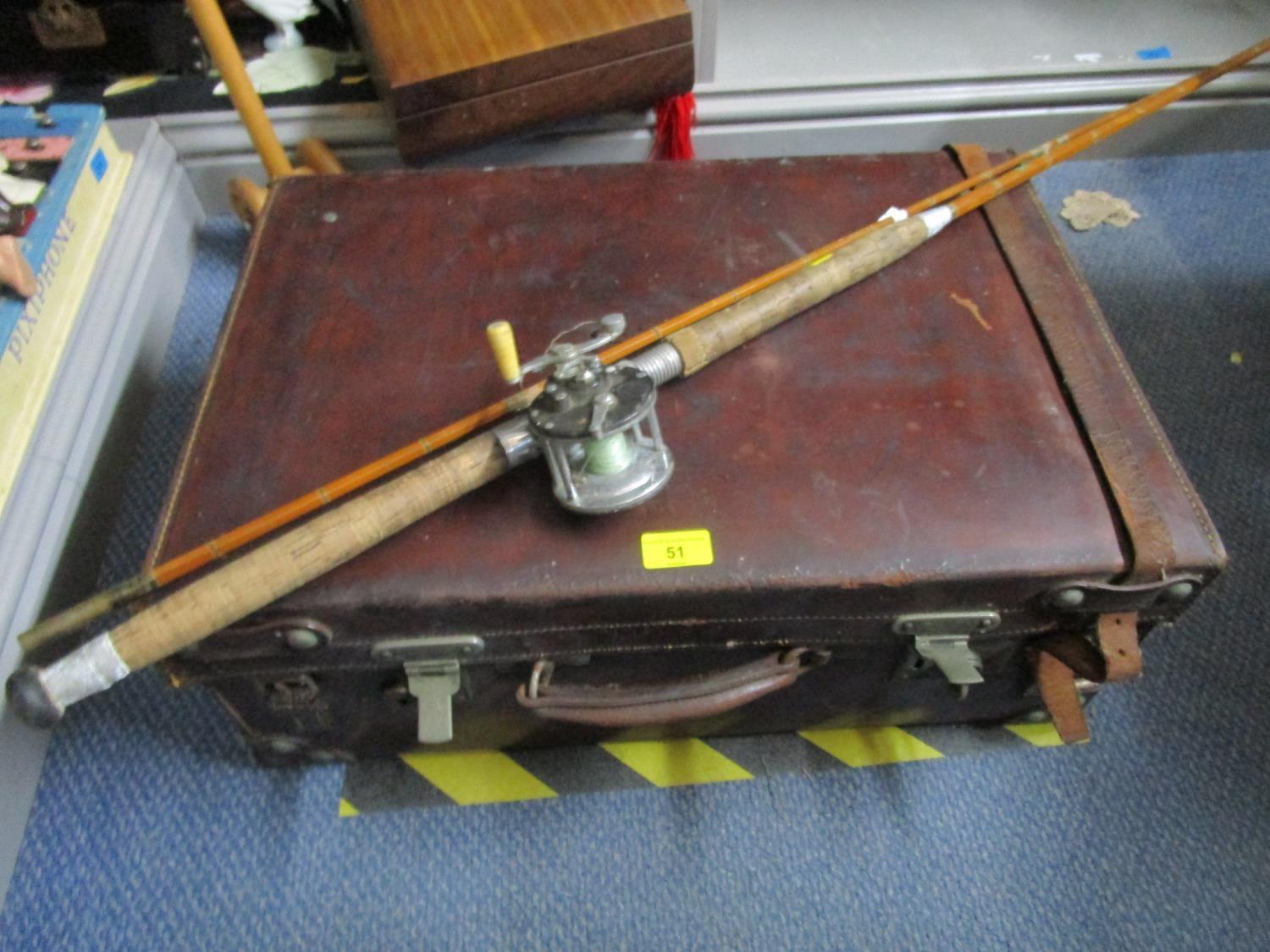 A Darnborough & Sons vintage leather travelling case and a split cane fishing rod with a Penn reel