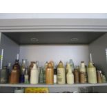 A collection of stoneware and glass bottles to include an Eastbourne Guildford and Worthing