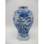 A late 18th century Dutch Delft vase of octagonal waisted form with a short neck, decorated in