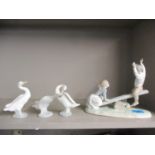 A Lladro model of a boy and girl on a seesaw together with three Lladro models of geese Location: