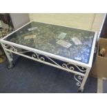 A vintage white metal and glass coffee table having a quantity of coins displayed under a glass