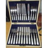 A cased set of early 20th century silver plated knives and forks on mother of pearl handles