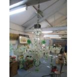 A traditional Venetian green and clear glass six branch chandelier with four daffodil stems and