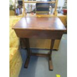 An old wooden school desk with hinged top and ink well compartment